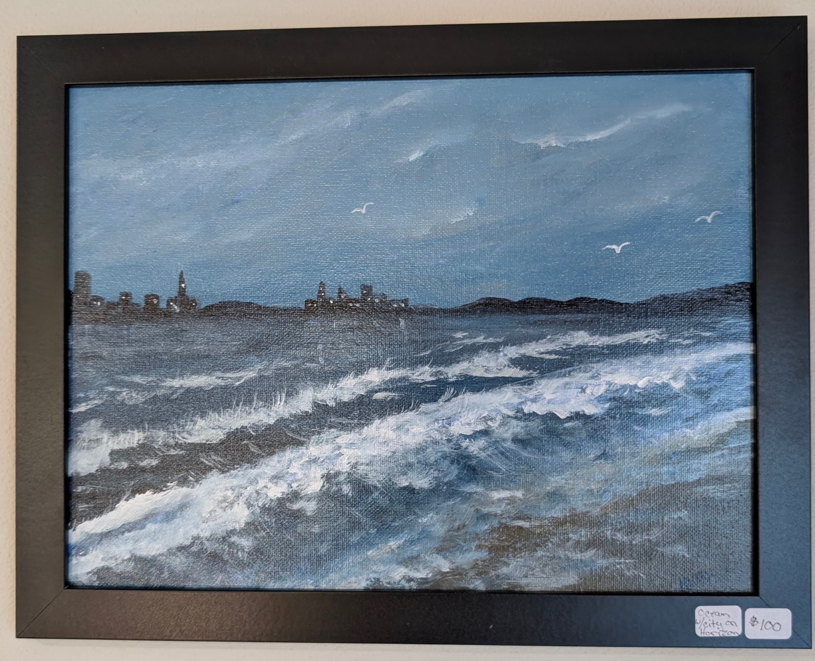 Acrylic seascape with choppy water and a distant city skyline across the bay