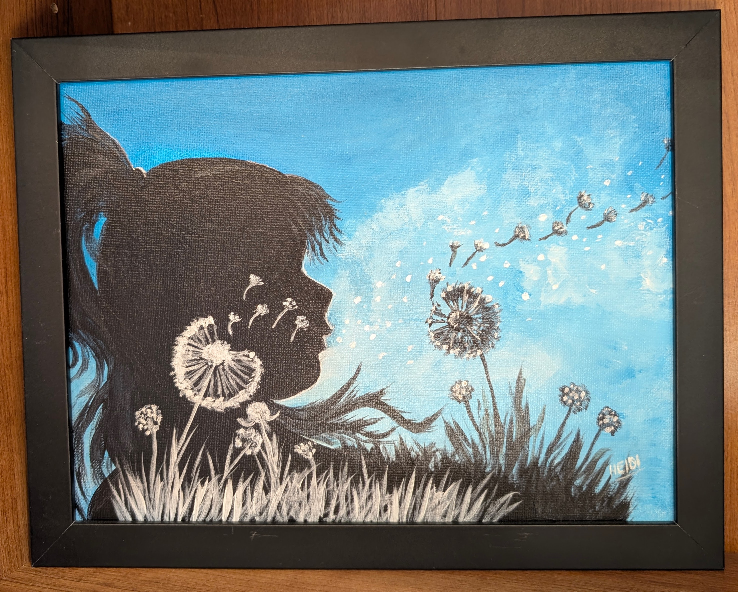 Framed acrylic silhouette painting: a child blowing dandelion seeds under a blue sky