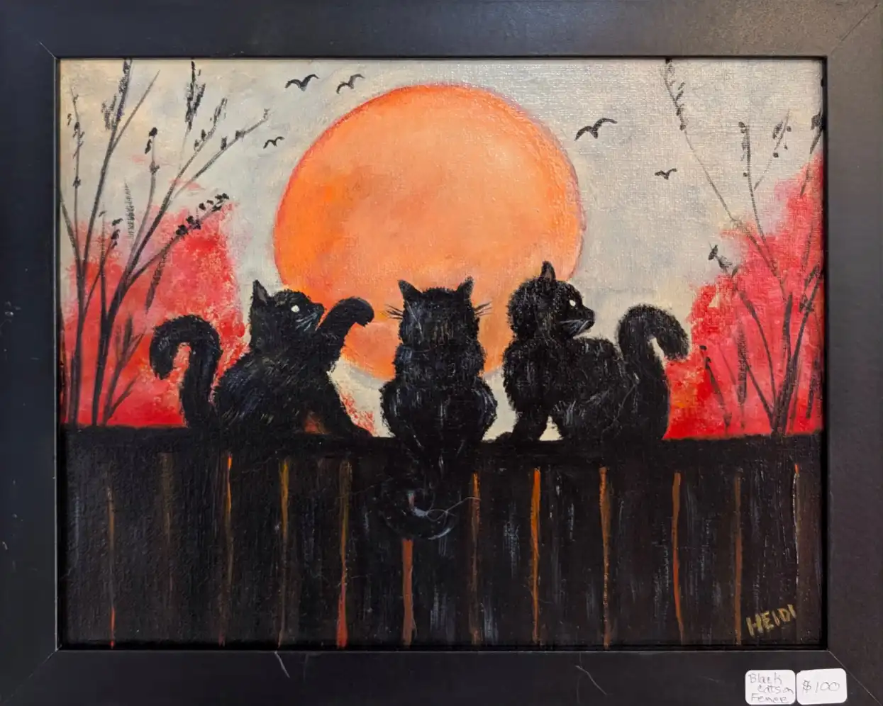 Black cats on a fence