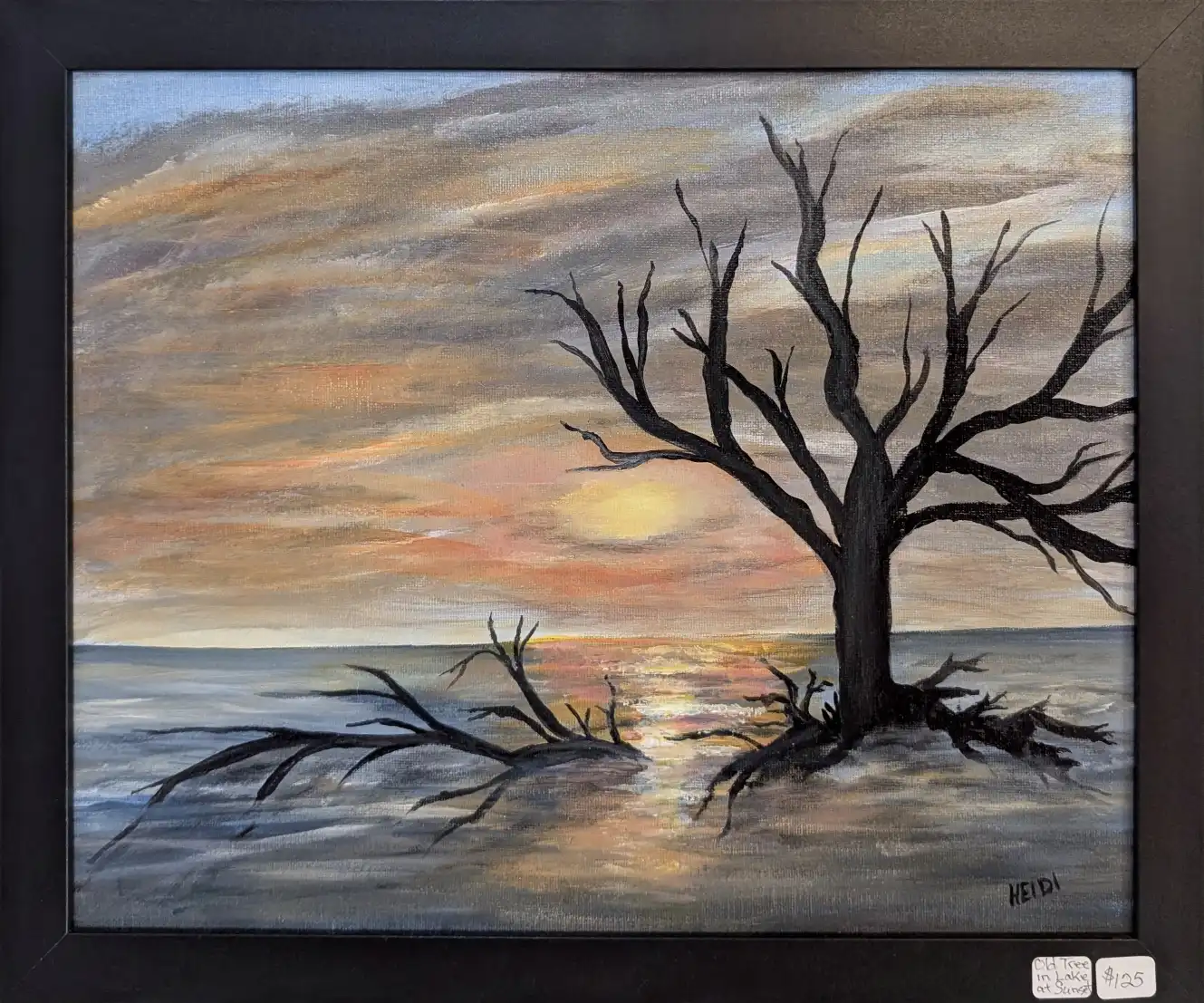 Old tree in lake at sunset